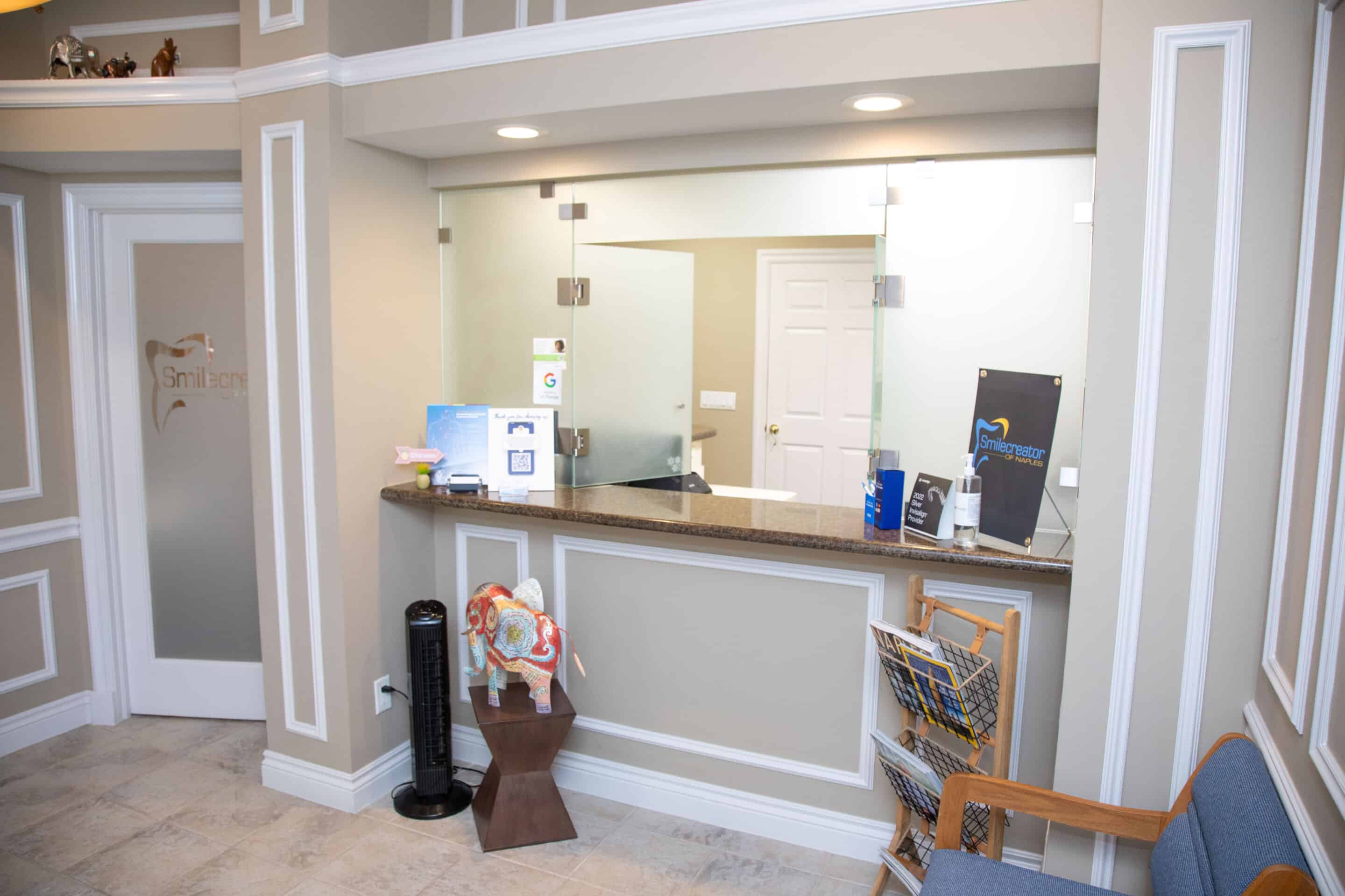 The front desk of the Naples location, within the brightly lit and inviting waiting room